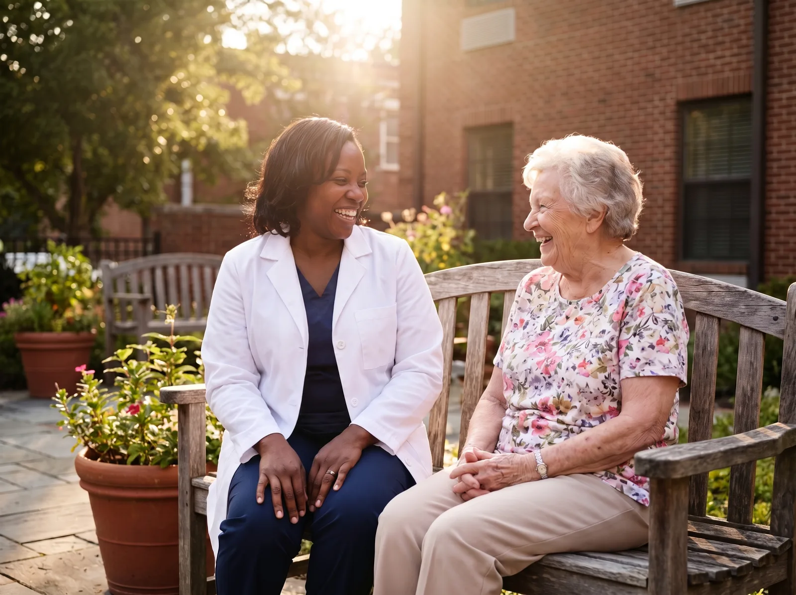 Journey Medical Group nurse practitioner sitting with an elderly resident on a garden bench